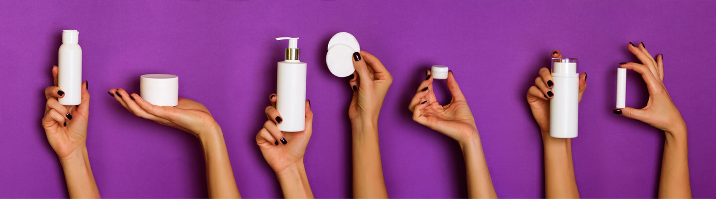 Hands Holding Personal Care Products on Purple Background